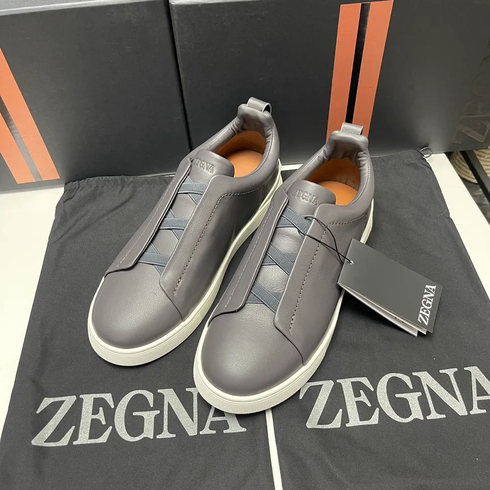 p670 ERMENEGILDO ZEGNA 傑尼亞男鞋 COUTURE Triple Stitch 運動鞋限量款 Triple Stitch 是一款精緻的休閒鞋履，飾有標誌性三重交叉鬆緊細節，靈感源於三重手縫線跡造型，彰顯了傑尼亞的悠久傳